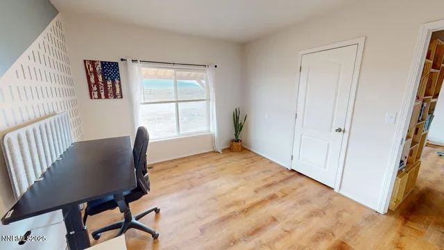 a view of a livingroom with furniture and a window