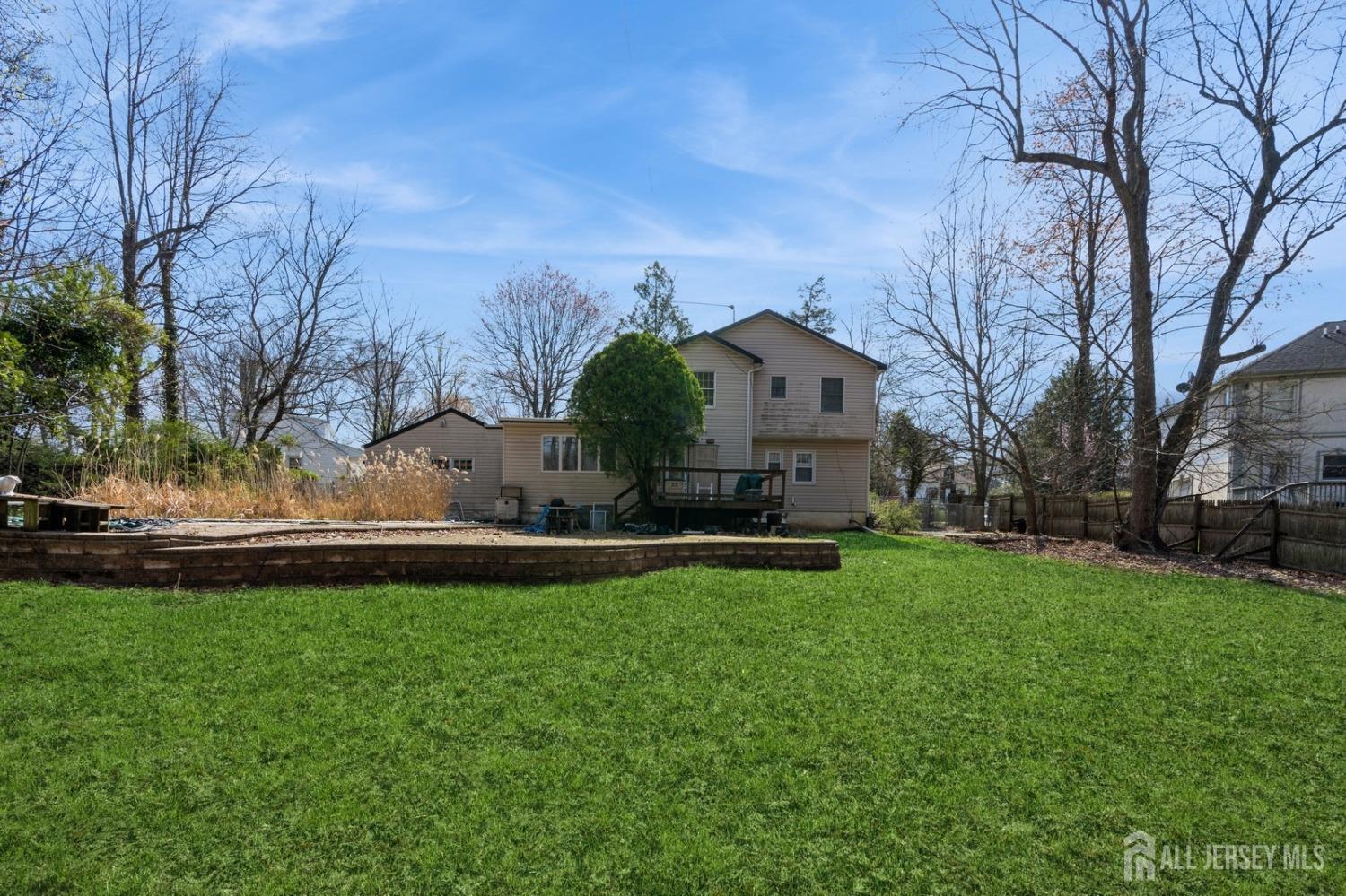 4 Stark Place Edison, NJ 08820 - Photo 2 of 12 a front view of a house with garden and trees