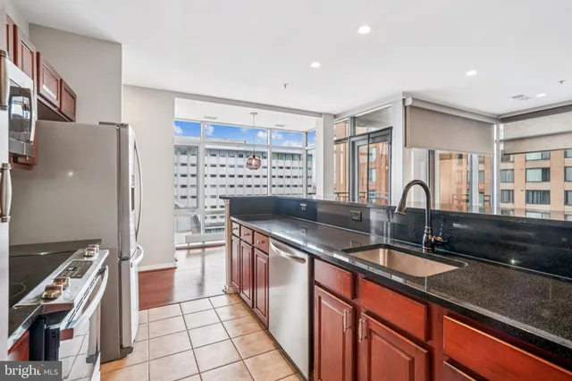 a kitchen with granite countertop a sink and a stove