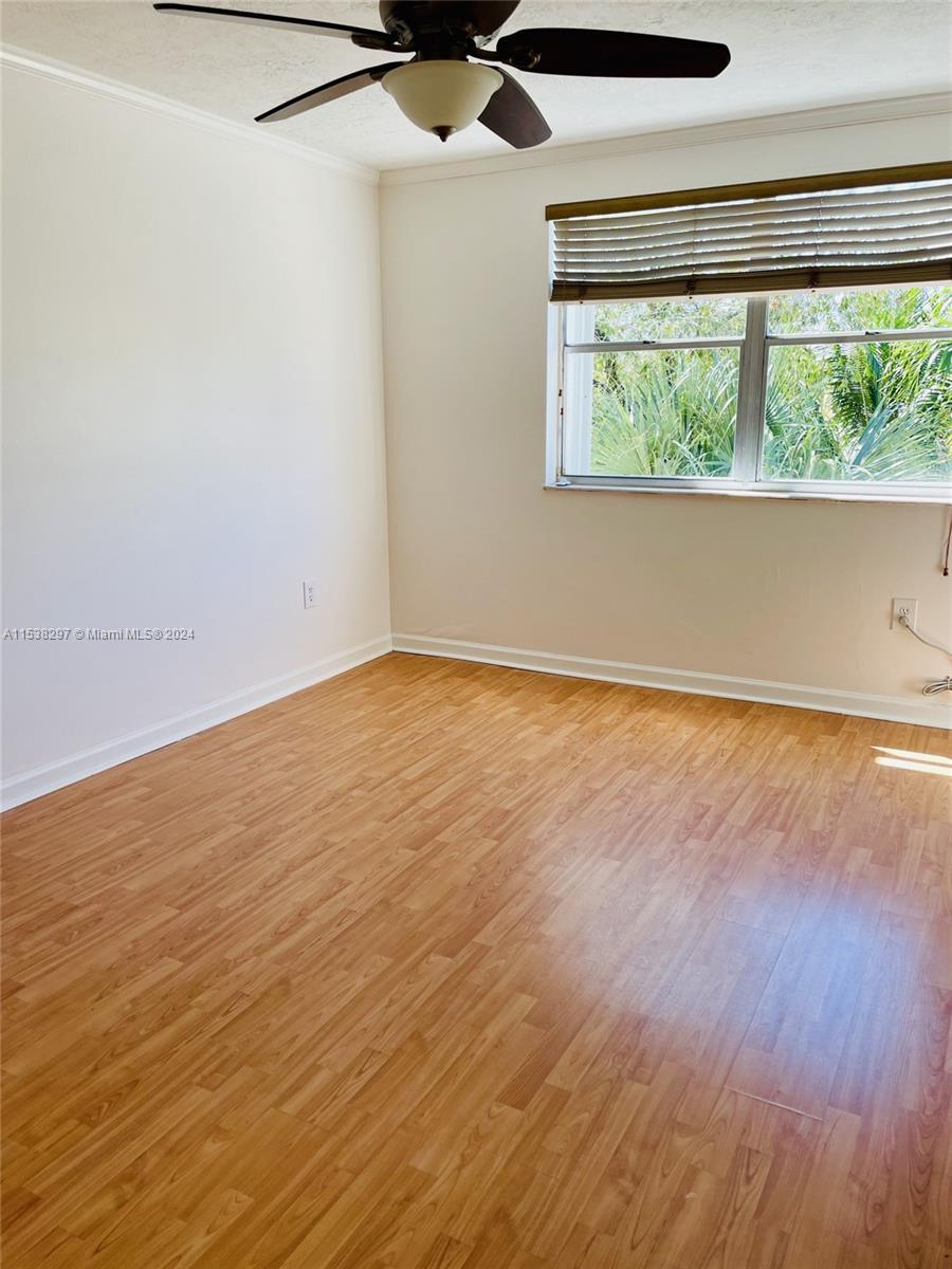 4530 Southwest 68th Ct Circle, Unit 356 Miami, FL 33155 - Photo 12 of 20 an empty room with wooden floor and windows
