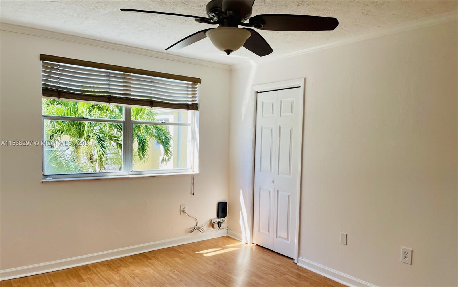4530 Southwest 68th Ct Circle, Unit 356 Miami, FL 33155 - Photo 13 of 20 an empty room with a window and a ceiling fan