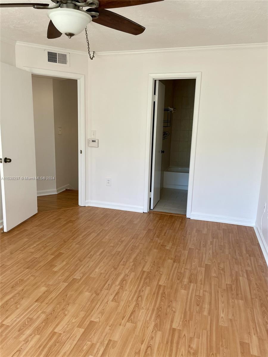 4530 Southwest 68th Ct Circle, Unit 356 Miami, FL 33155 - Photo 14 of 20 a view of an empty room with wooden floor