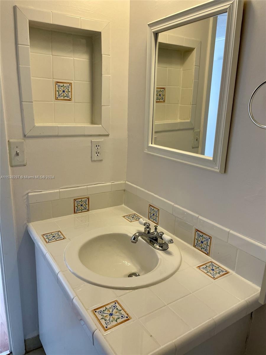 4530 Southwest 68th Ct Circle, Unit 356 Miami, FL 33155 - Photo 15 of 20 a bathroom with a sink and a mirror