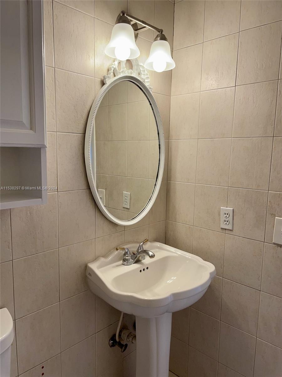 4530 Southwest 68th Ct Circle, Unit 356 Miami, FL 33155 - Photo 16 of 20 a bathroom with a sink and a mirror