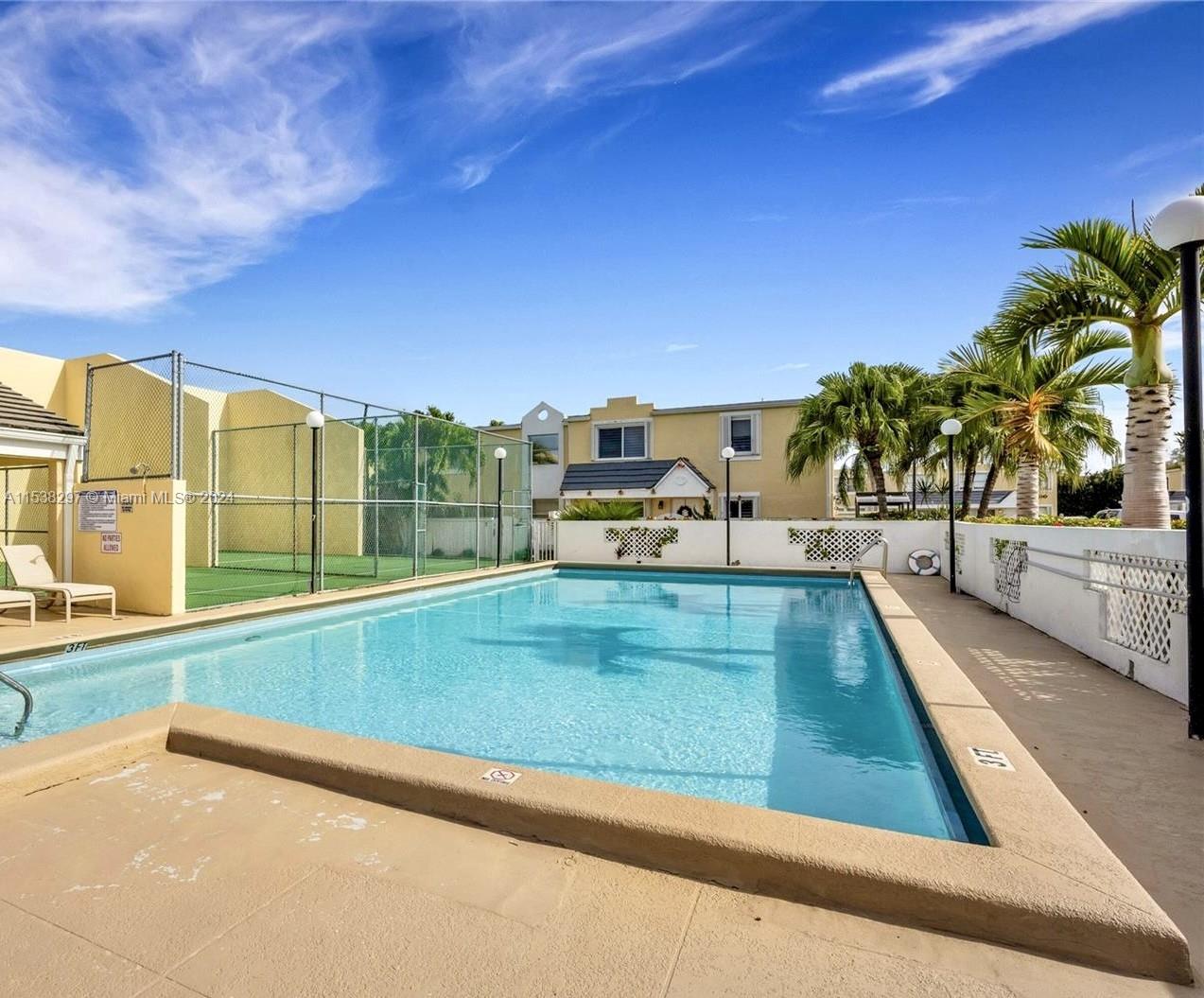 4530 Southwest 68th Ct Circle, Unit 356 Miami, FL 33155 - Photo 19 of 20 a view of a swimming pool with a lawn chairs