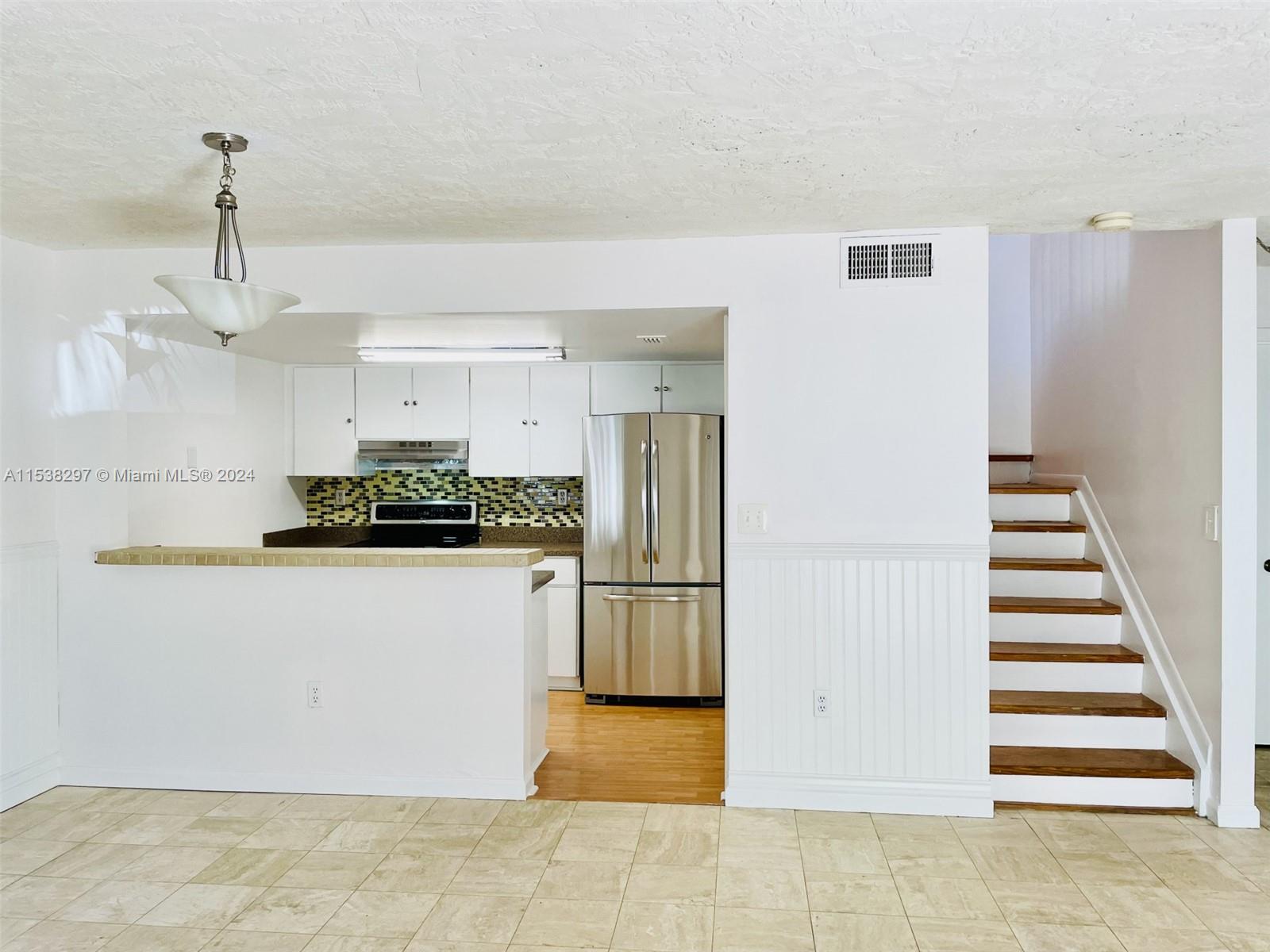 4530 Southwest 68th Ct Circle, Unit 356 Miami, FL 33155 - Photo 5 of 20 a kitchen with stainless steel appliances a refrigerator and a stove top oven