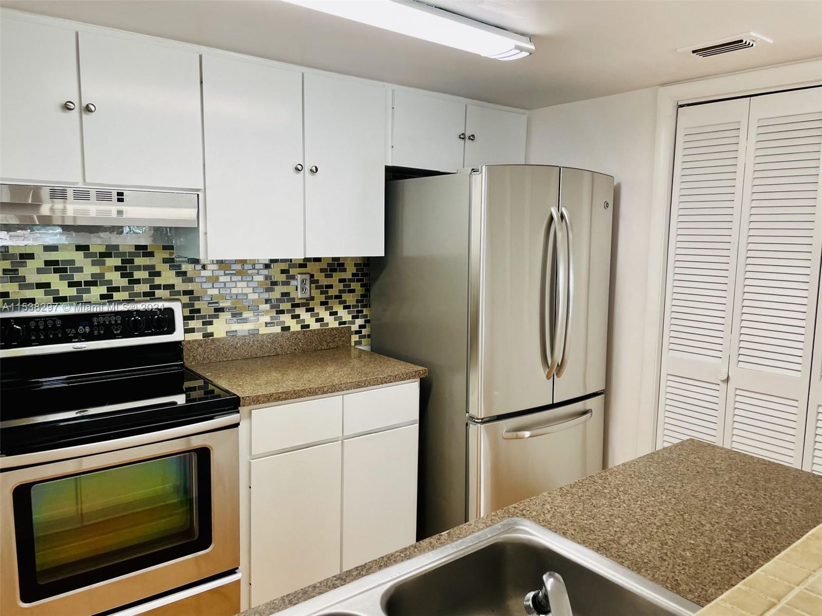 4530 Southwest 68th Ct Circle, Unit 356 Miami, FL 33155 - Photo 6 of 20 a kitchen with appliances and cabinets