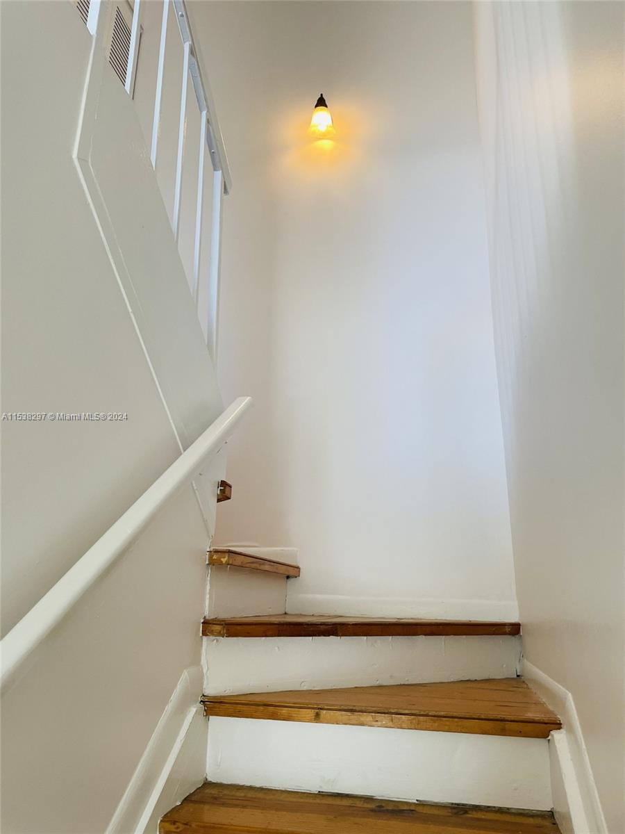 4530 Southwest 68th Ct Circle, Unit 356 Miami, FL 33155 - Photo 8 of 20 a view of staircase with white walls and a window