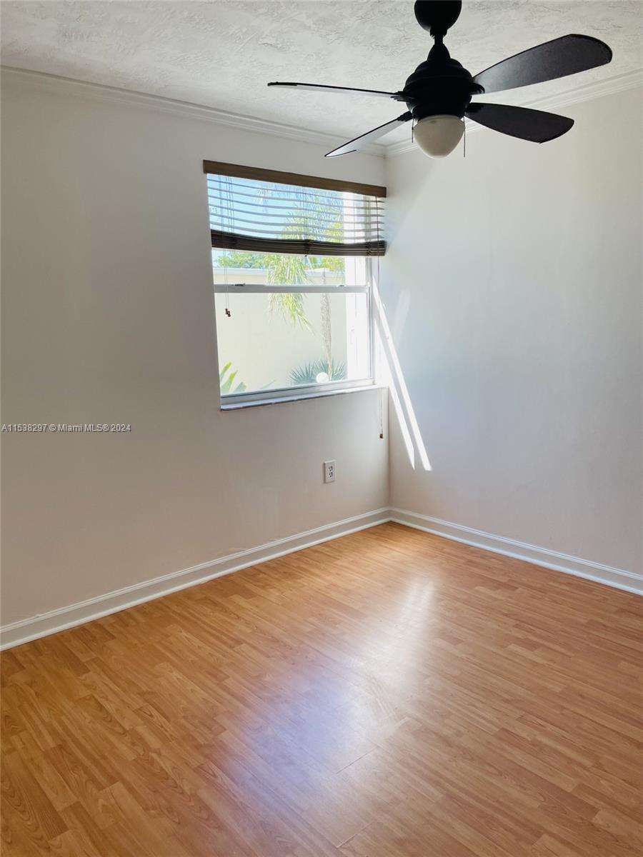 4530 Southwest 68th Ct Circle, Unit 356 Miami, FL 33155 - Photo 10 of 20 an empty room with a window and wooden floor