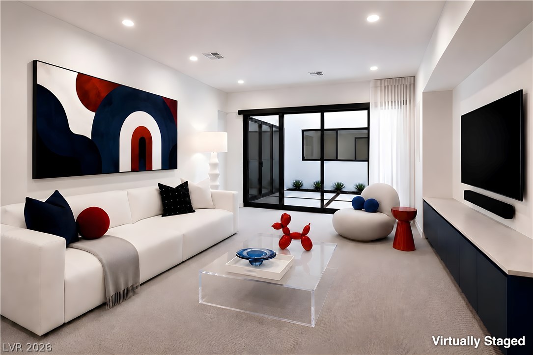25 Falling Ridge Lane Henderson, NV 89011 - Photo 6 of 48 A well-lit, contemporary living space with sliding glass doors opening to a private courtyard.