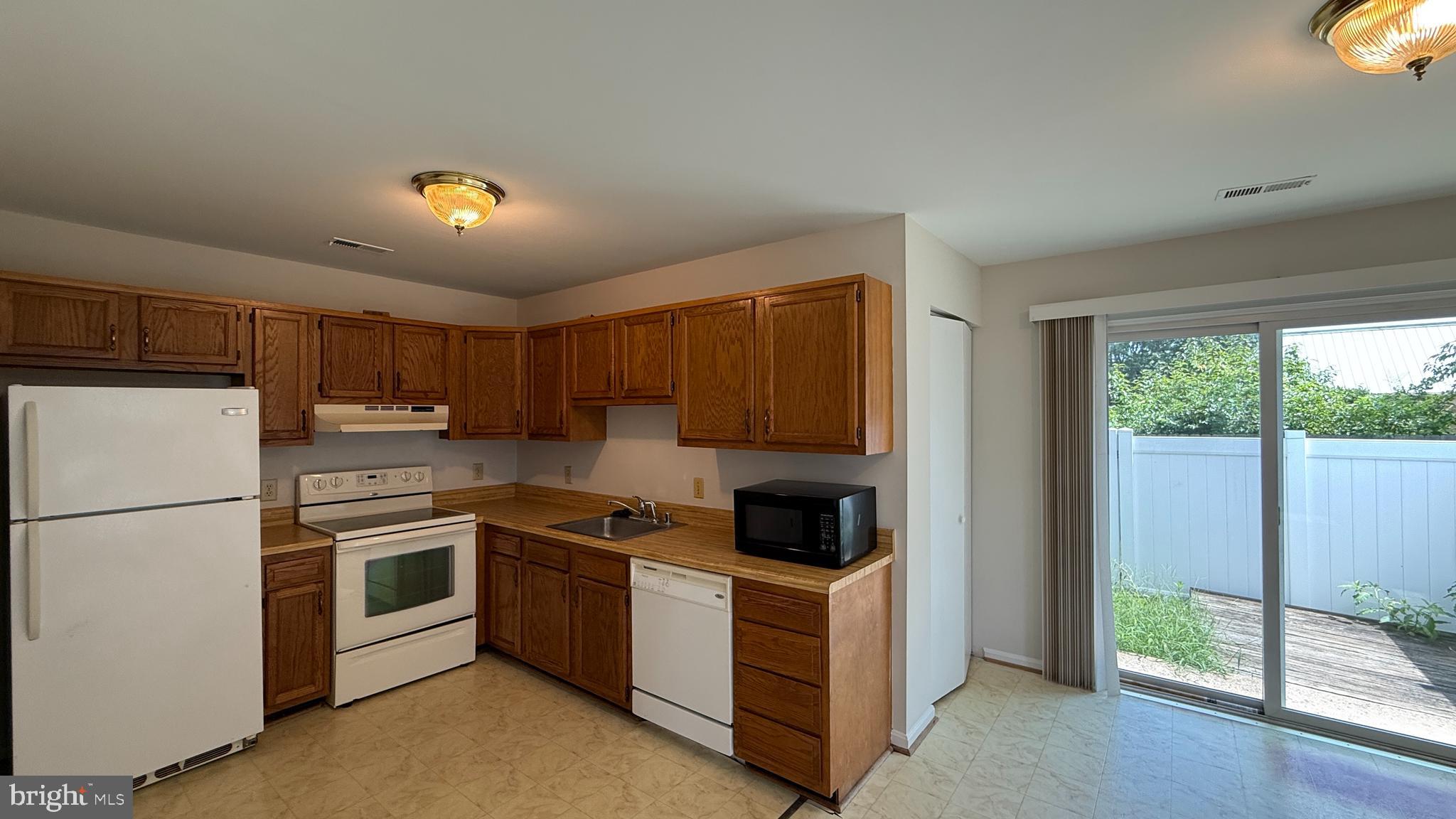 200 Surry Lane, Unit 118 Stafford, VA 22556 - Photo 2 of 13 a kitchen with a refrigerator sink and stove top oven