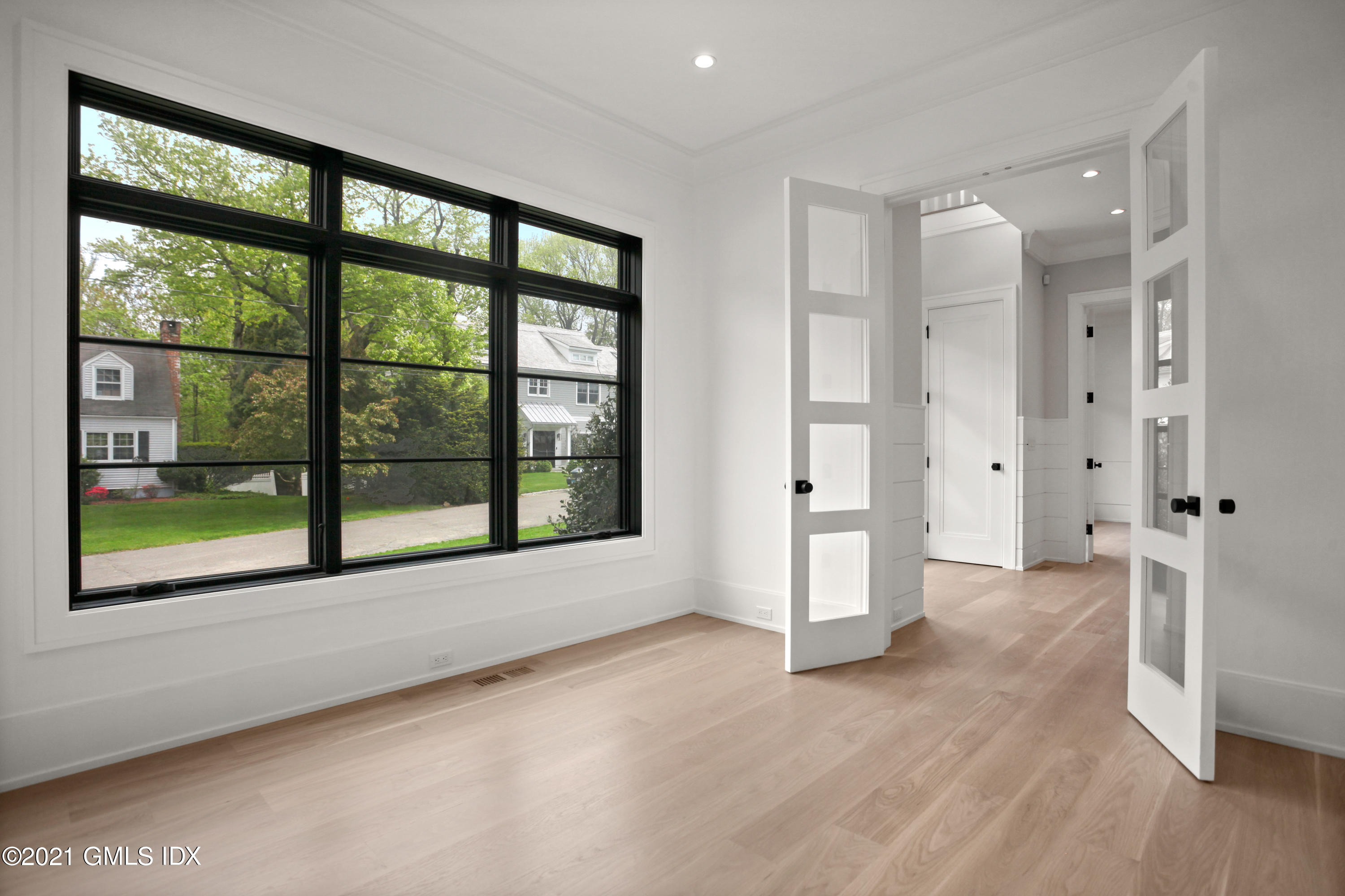 12 Dialstone Lane Riverside, CT 06878 - Photo 13 of 66 a view of an empty room with a window and wooden floor