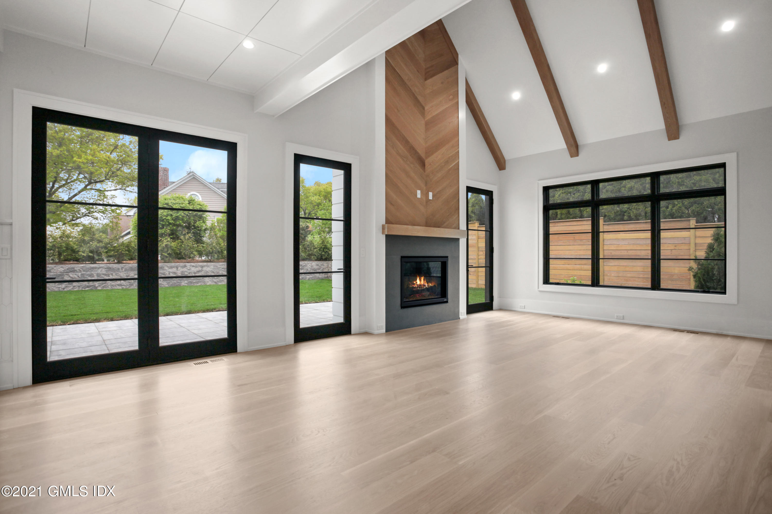 12 Dialstone Lane Riverside, CT 06878 - Photo 22 of 66 wooden floor fireplace and windows in an empty room