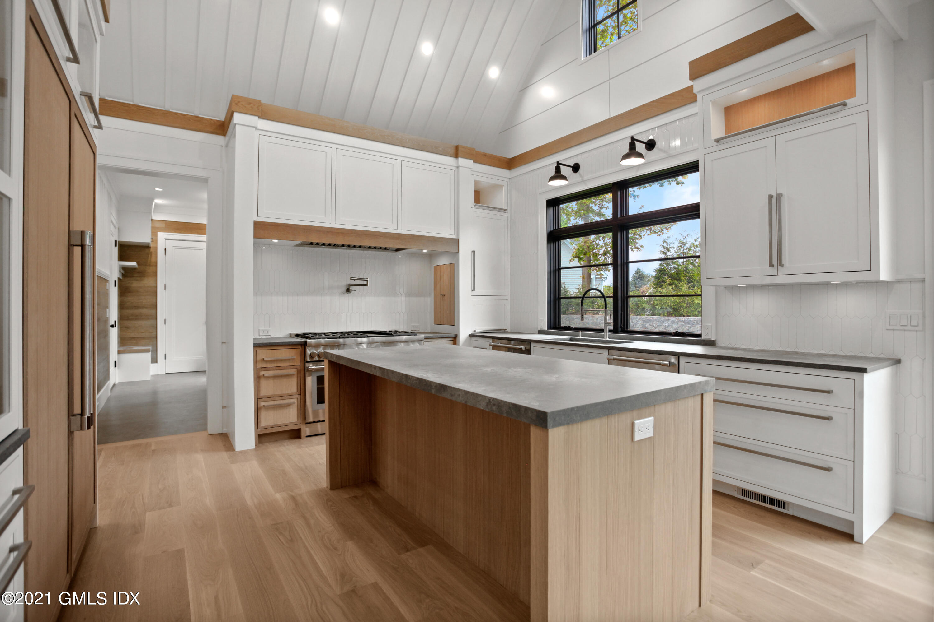 12 Dialstone Lane Riverside, CT 06878 - Photo 25 of 66 a kitchen with stainless steel appliances granite countertop a lot of counter space and wooden floors