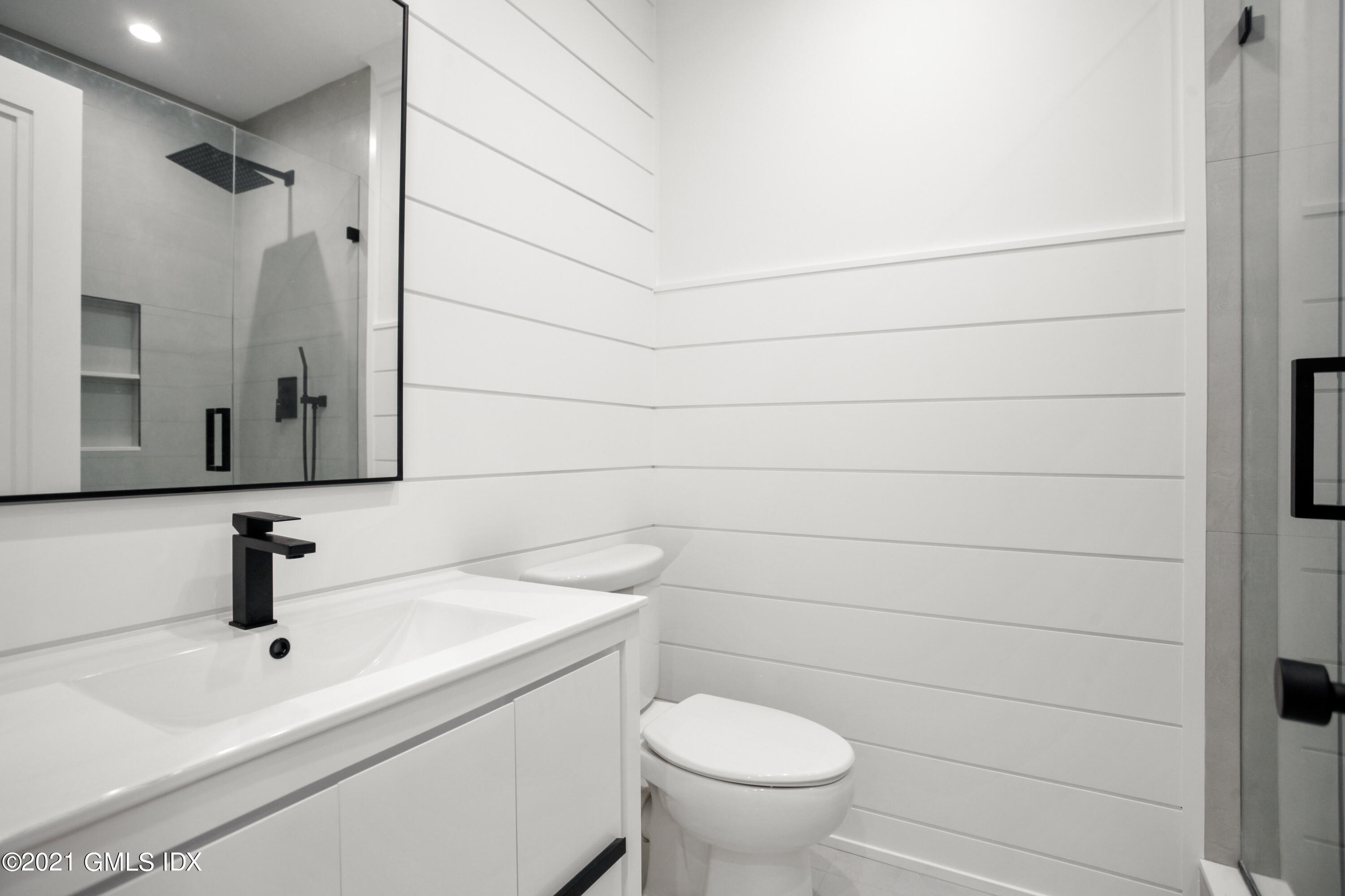 12 Dialstone Lane Riverside, CT 06878 - Photo 55 of 66 a bathroom with a sink a toilet and mirror