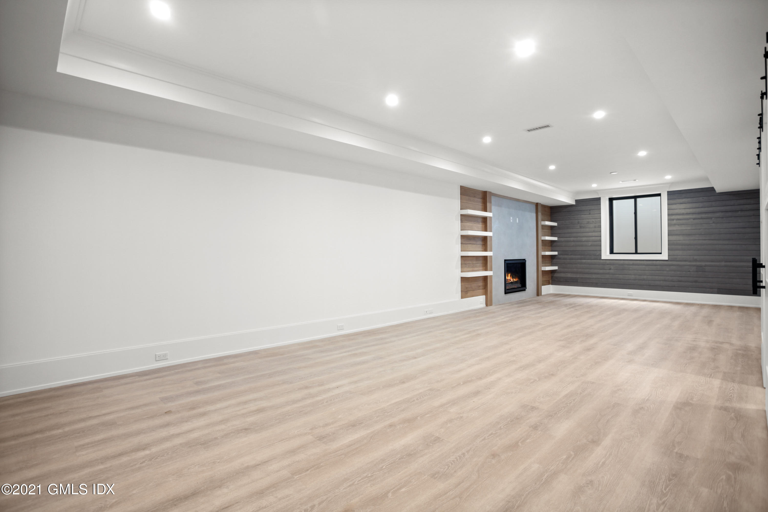 12 Dialstone Lane Riverside, CT 06878 - Photo 59 of 66 a view of an empty room with wooden floor and windows