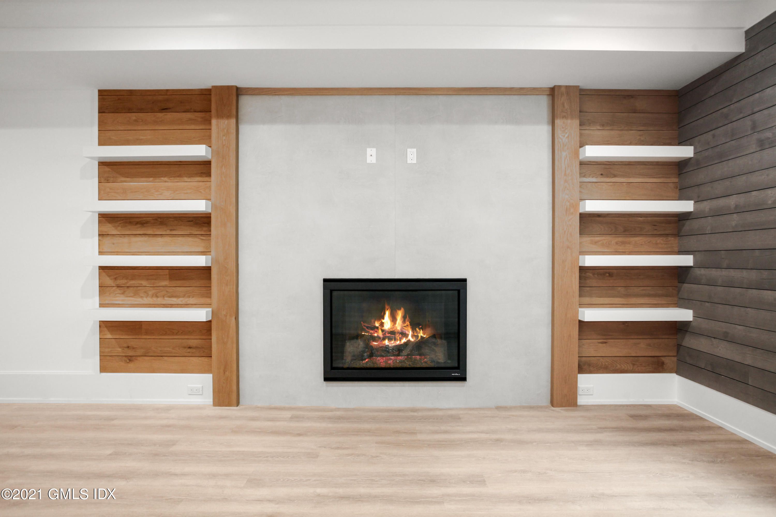 12 Dialstone Lane Riverside, CT 06878 - Photo 62 of 66 a view of an empty room and kitchen with fireplace