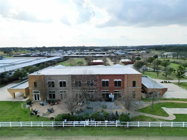an aerial view of a house with a big yard and large trees