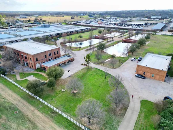 an aerial view of a house with a garden and a swimming pool
