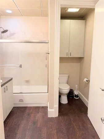 a bathroom with a toilet and a shower