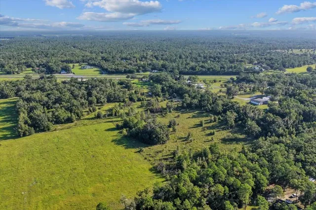 an aerial view of a house with a yard
