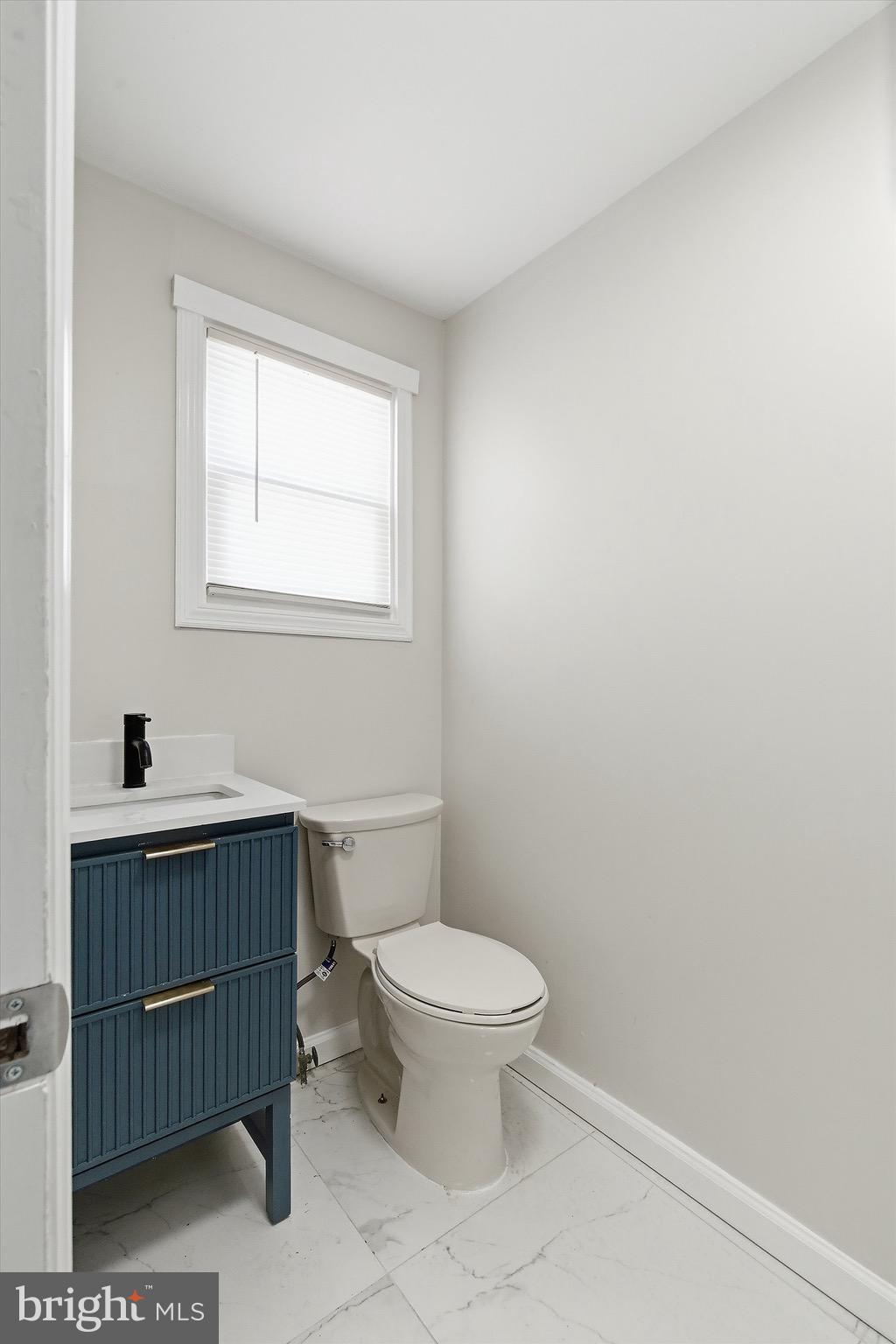 1000 West 3rd Street Florence, NJ 08518 - Photo 19 of 42 a bathroom with a toilet a sink and a window
