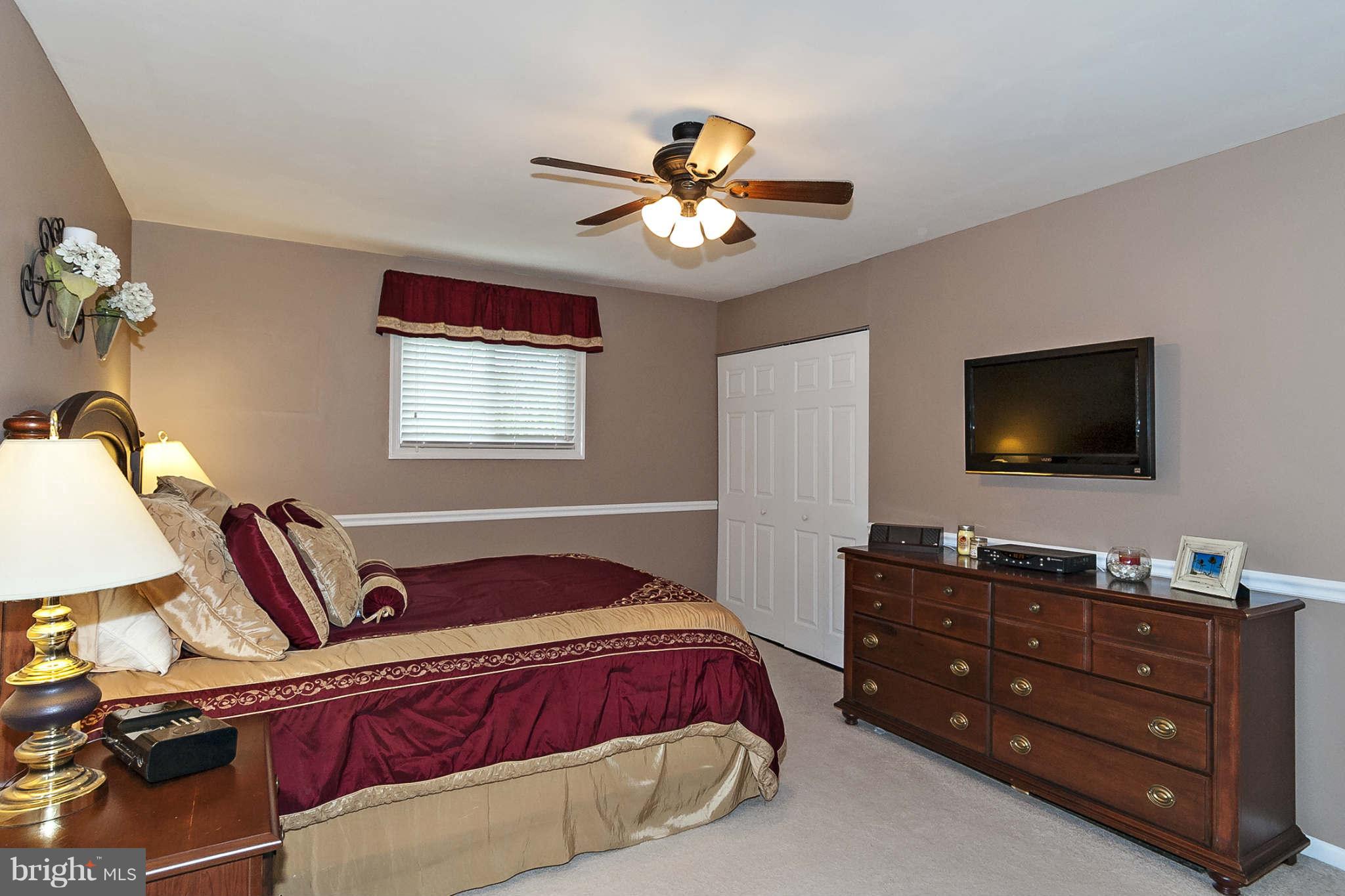 2003 Helmsby Road Baltimore, MD 21228 - Photo 15 of 26 a bedroom with a bed and a flat screen tv
