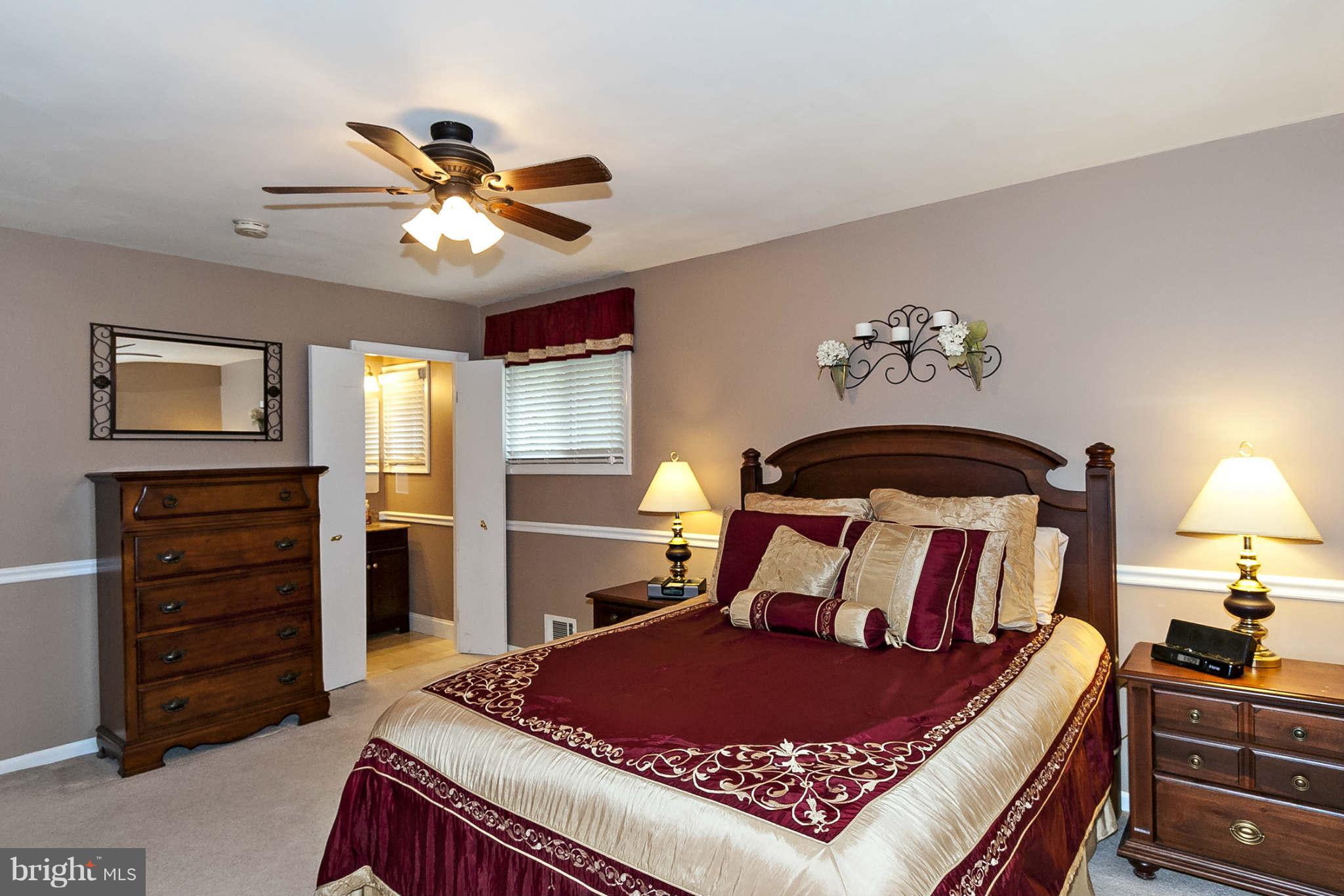 2003 Helmsby Road Baltimore, MD 21228 - Photo 16 of 26 a bedroom with a bed and a chandelier