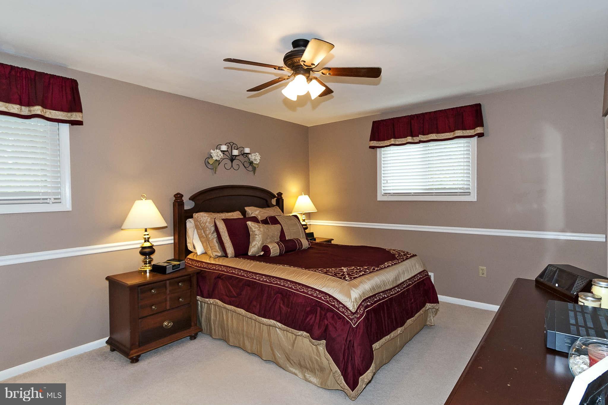 2003 Helmsby Road Baltimore, MD 21228 - Photo 17 of 26 a bedroom with a bed and a chandelier