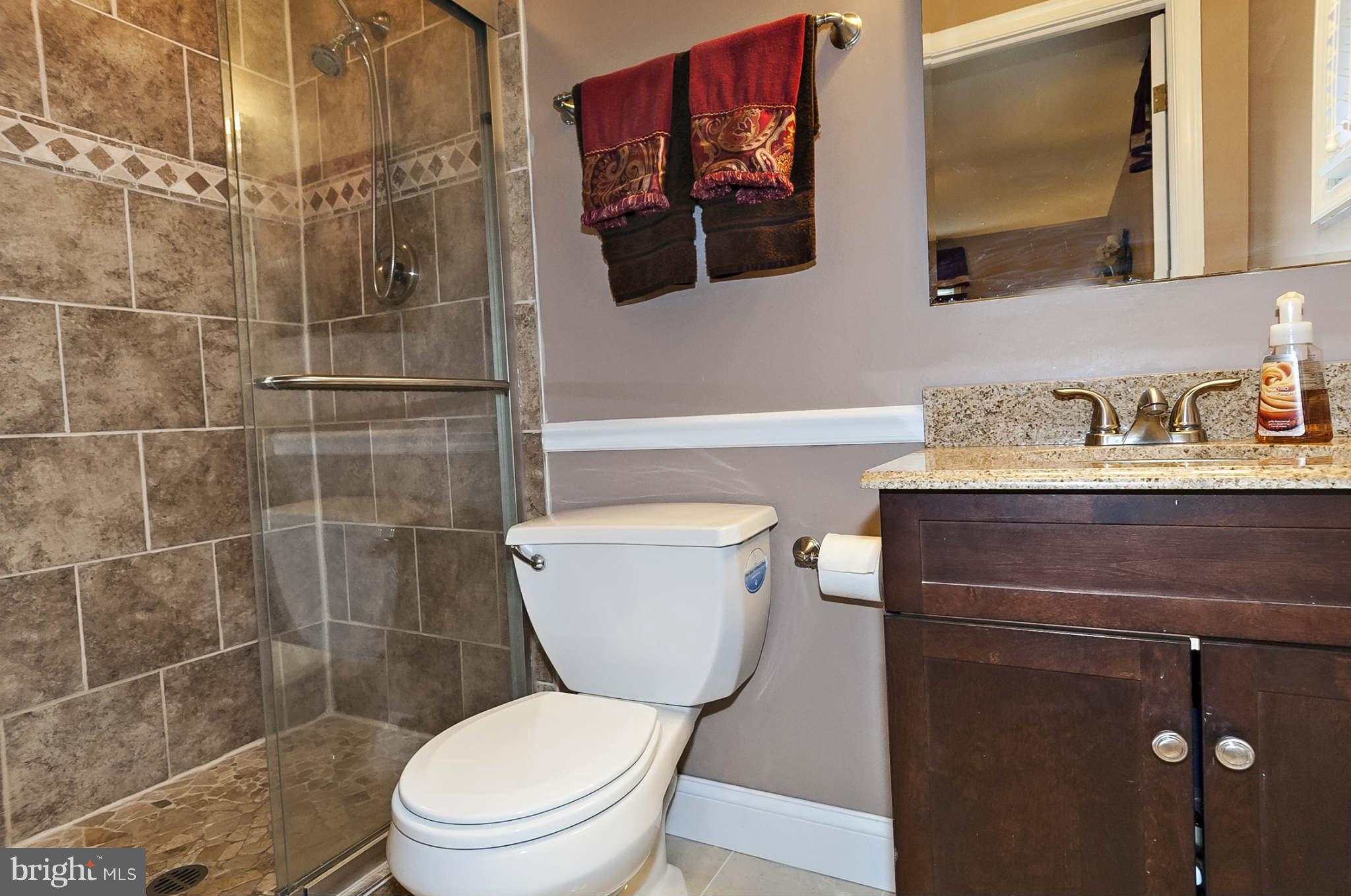 2003 Helmsby Road Baltimore, MD 21228 - Photo 18 of 26 a bathroom with a toilet a sink and mirror