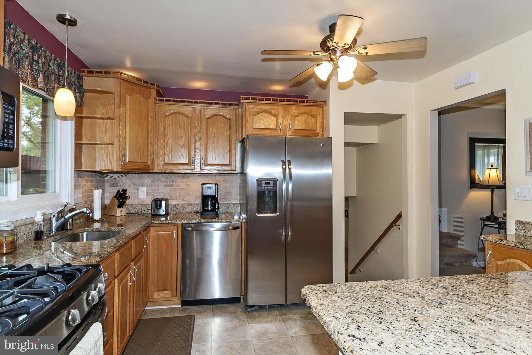 2003 Helmsby Road Baltimore, MD 21228 - Photo 6 of 26 a kitchen with stainless steel appliances granite countertop a sink a stove and a refrigerator