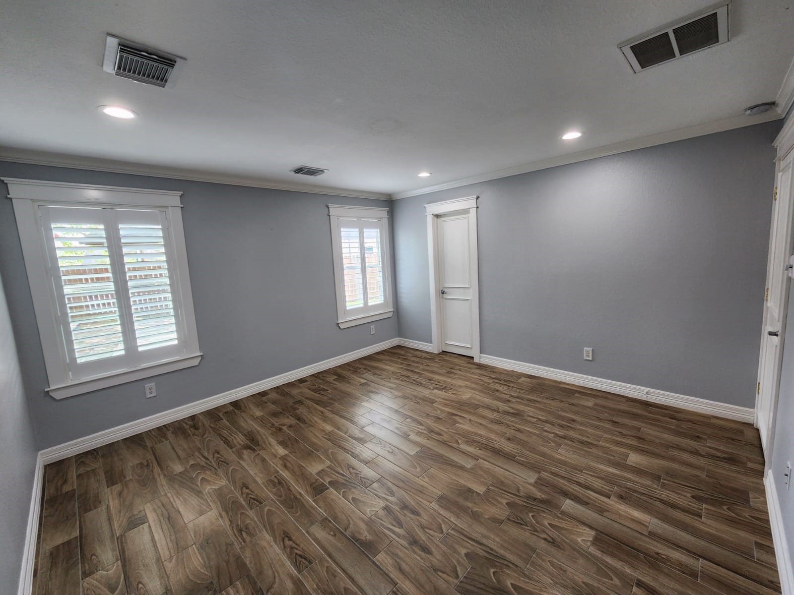 15506 Red Pine Ridge Way Houston, TX 77049 - Photo 24 of 49 an empty room with wooden floor and windows
