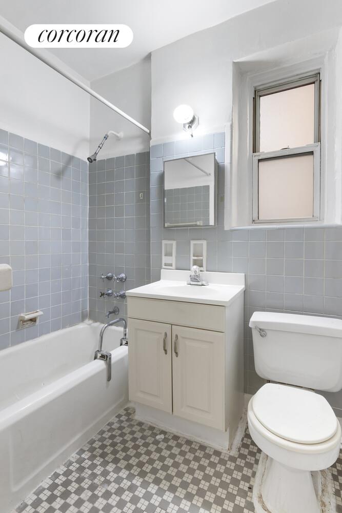 414 Albemarle Road, Unit 1D Brooklyn, NY 11218 - Photo 10 of 13 a bathroom with a sink toilet vanity and bathtub