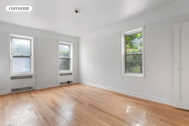 a bedroom with a large bed and a potted plant