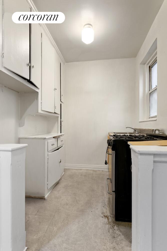 414 Albemarle Road, Unit 1D Brooklyn, NY 11218 - Photo 7 of 13 a utility room with cabinets