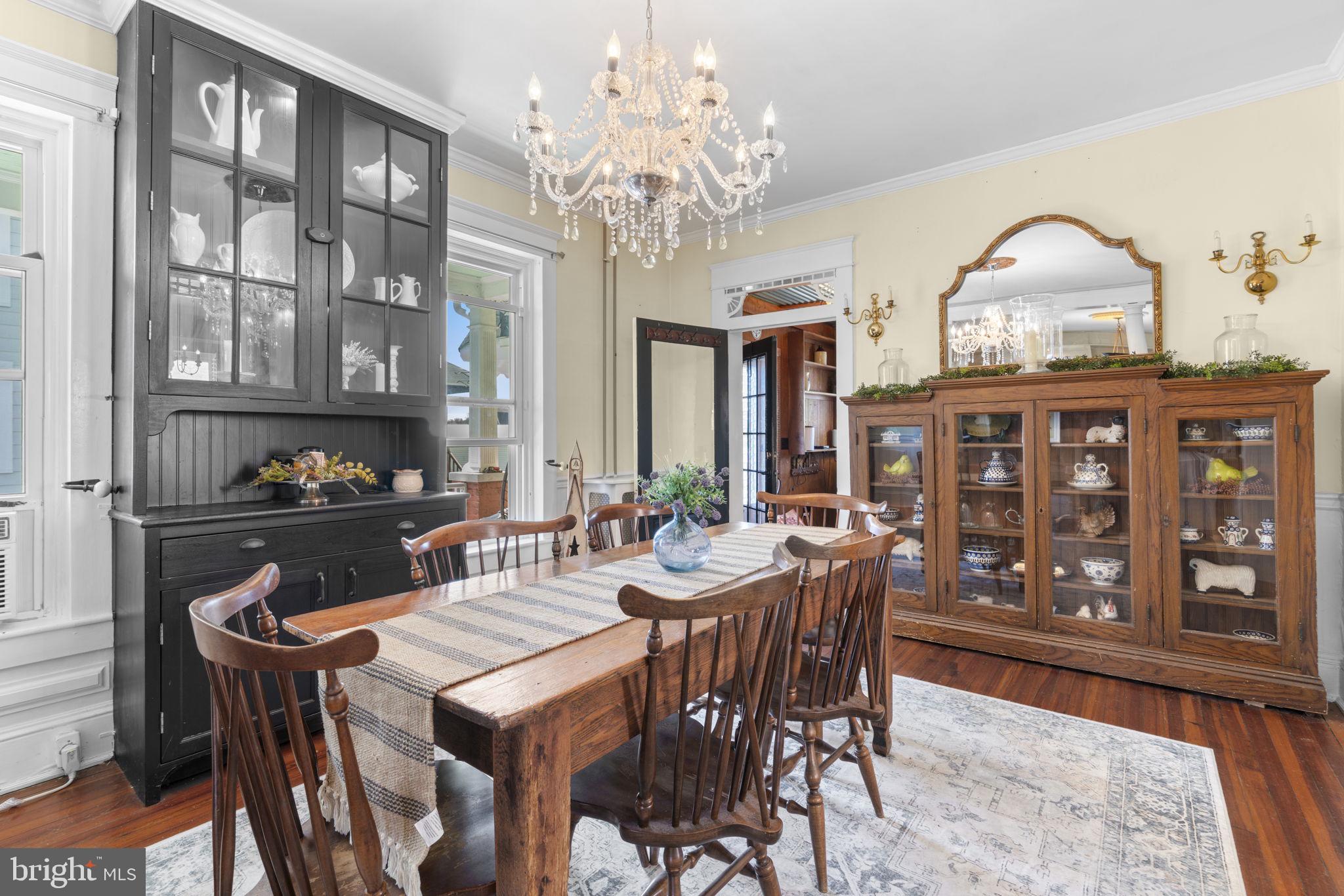 1916 Hanover Pike Hampstead, MD 21074 - Photo 11 of 46 a view of a dining room with furniture chandelier and wooden floor