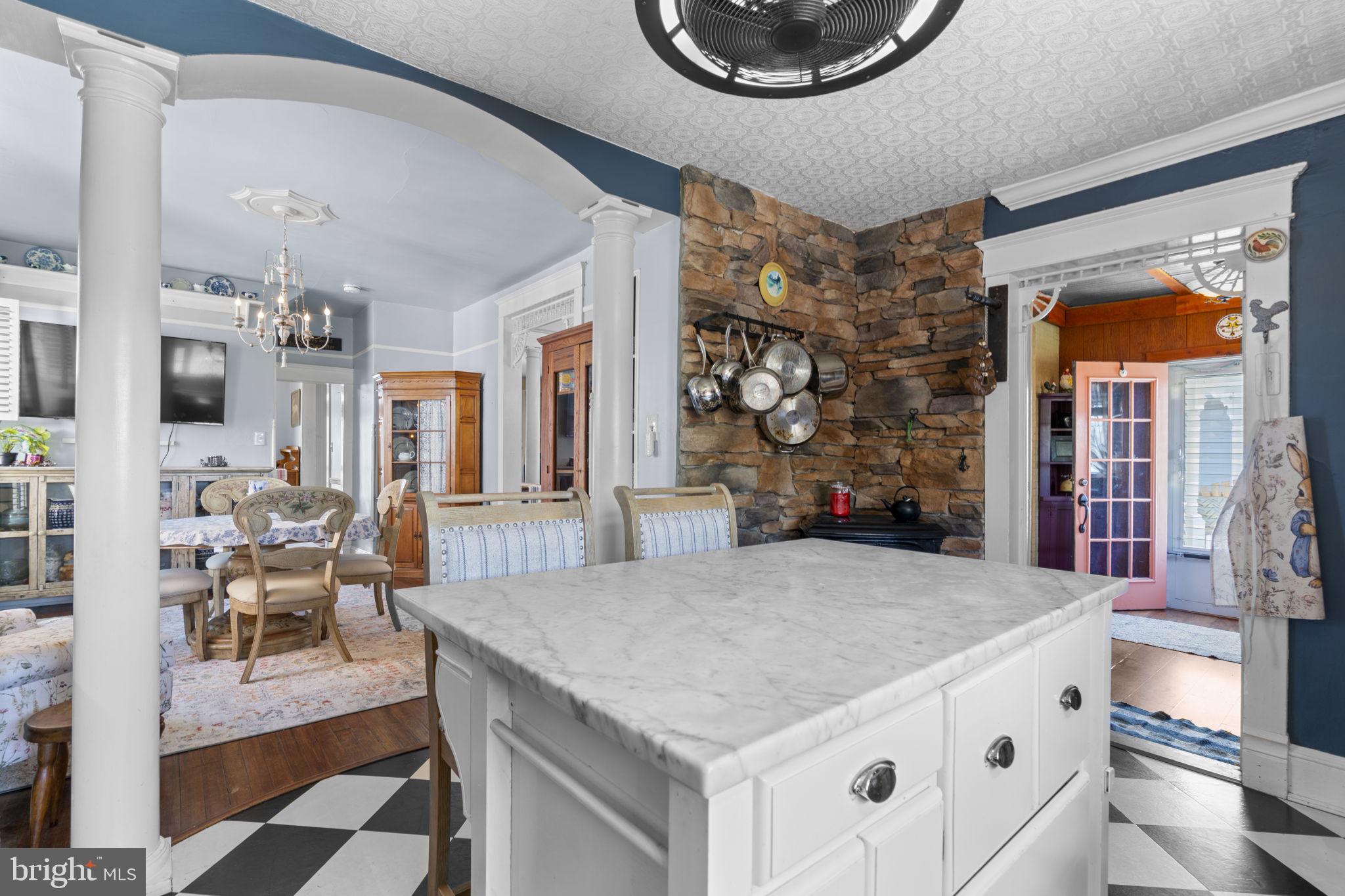1916 Hanover Pike Hampstead, MD 21074 - Photo 19 of 46 a kitchen with a table chairs and a stove