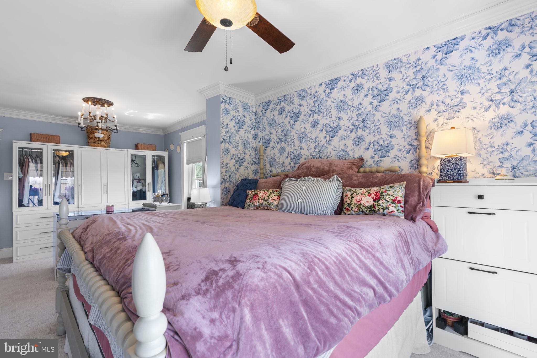 1916 Hanover Pike Hampstead, MD 21074 - Photo 26 of 46 a spacious bedroom with a bed and cabinets