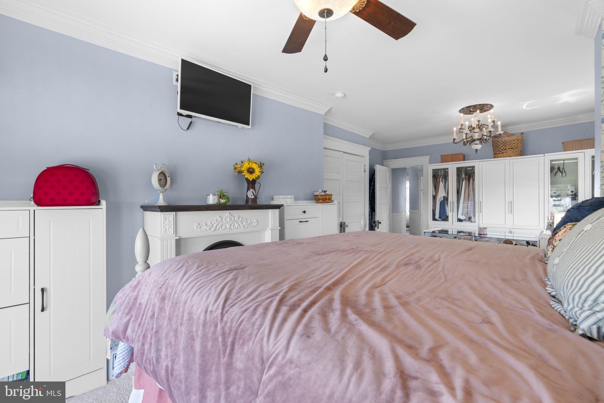 1916 Hanover Pike Hampstead, MD 21074 - Photo 27 of 46 a bedroom with a bed and a chandelier