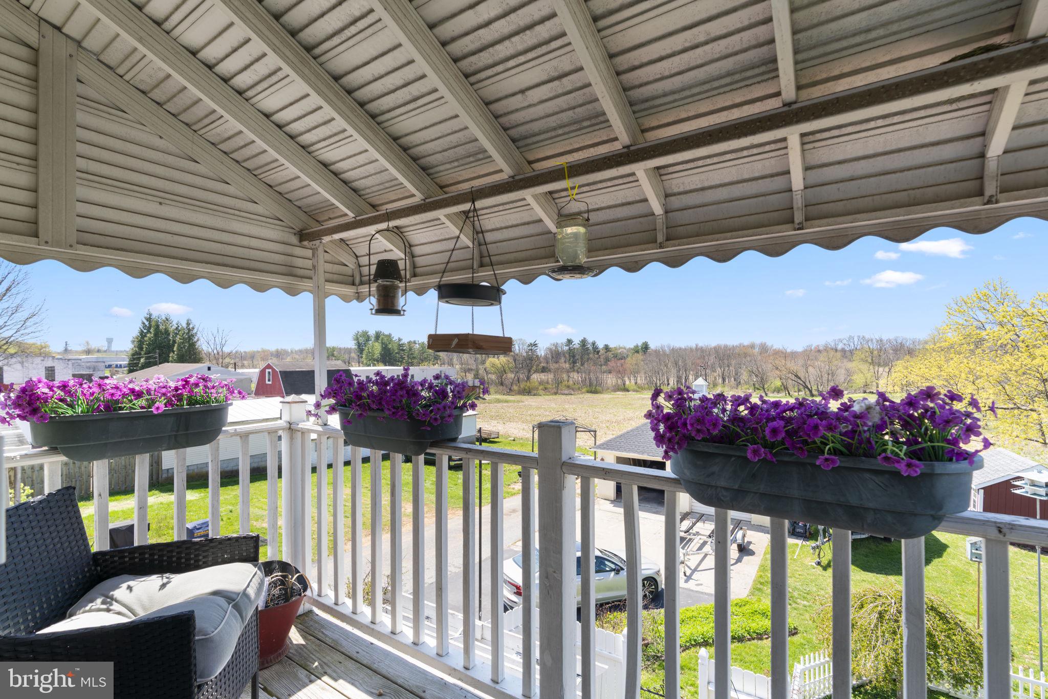 1916 Hanover Pike Hampstead, MD 21074 - Photo 29 of 46 a view of a porch with a dining table and chairs