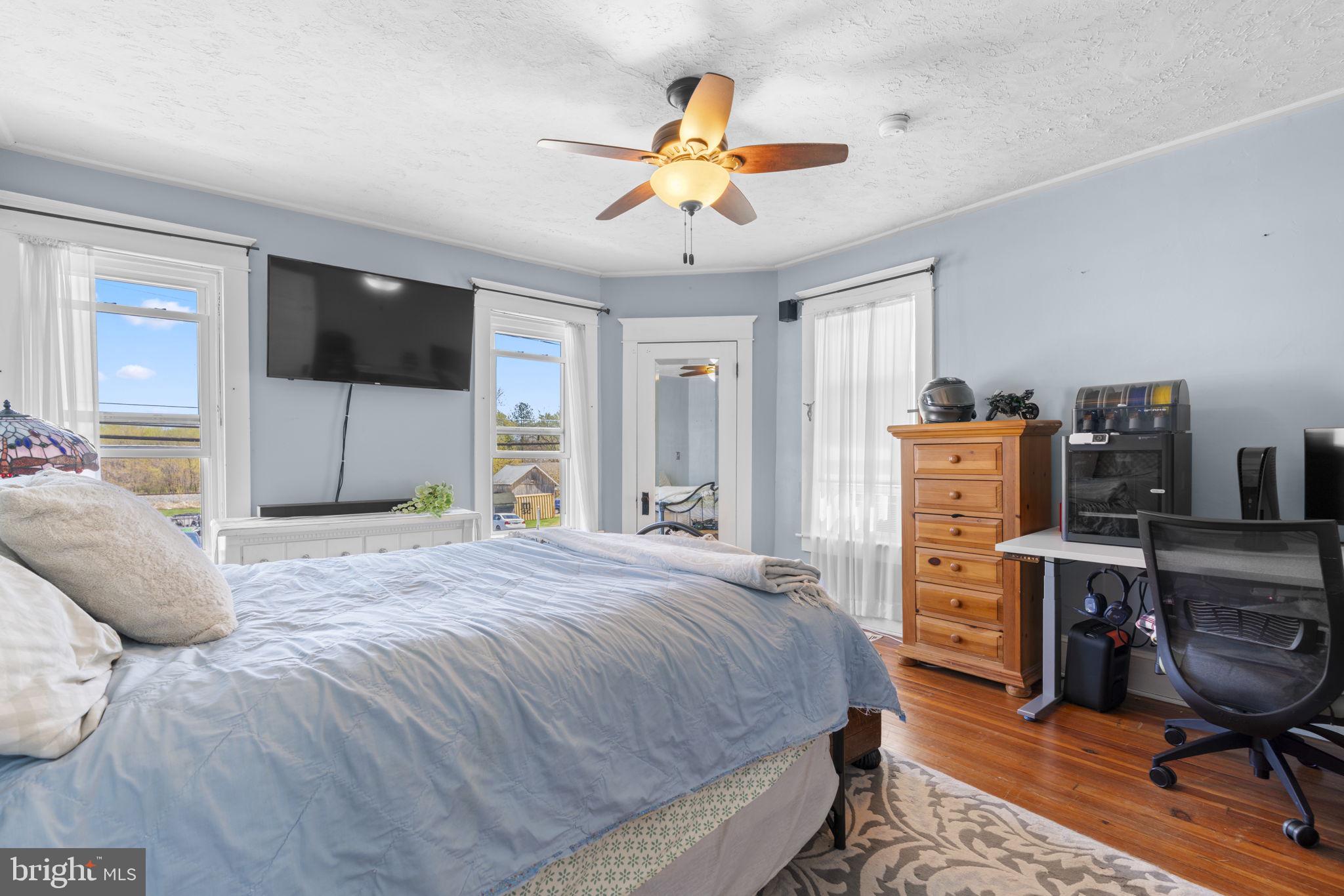 1916 Hanover Pike Hampstead, MD 21074 - Photo 34 of 46 a bedroom with a bed and a flat screen tv