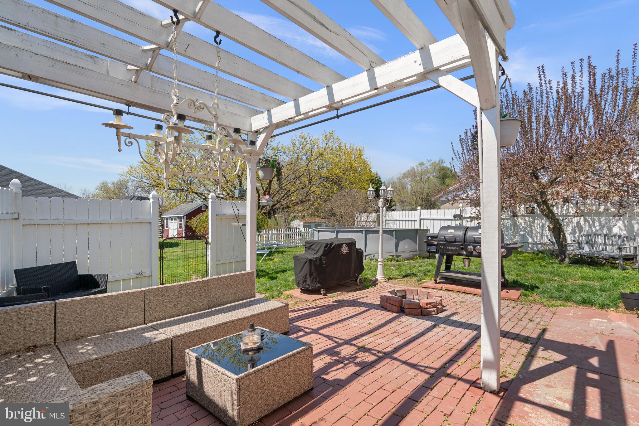 1916 Hanover Pike Hampstead, MD 21074 - Photo 37 of 46 a view of a patio with a dining table and chairs with a porch