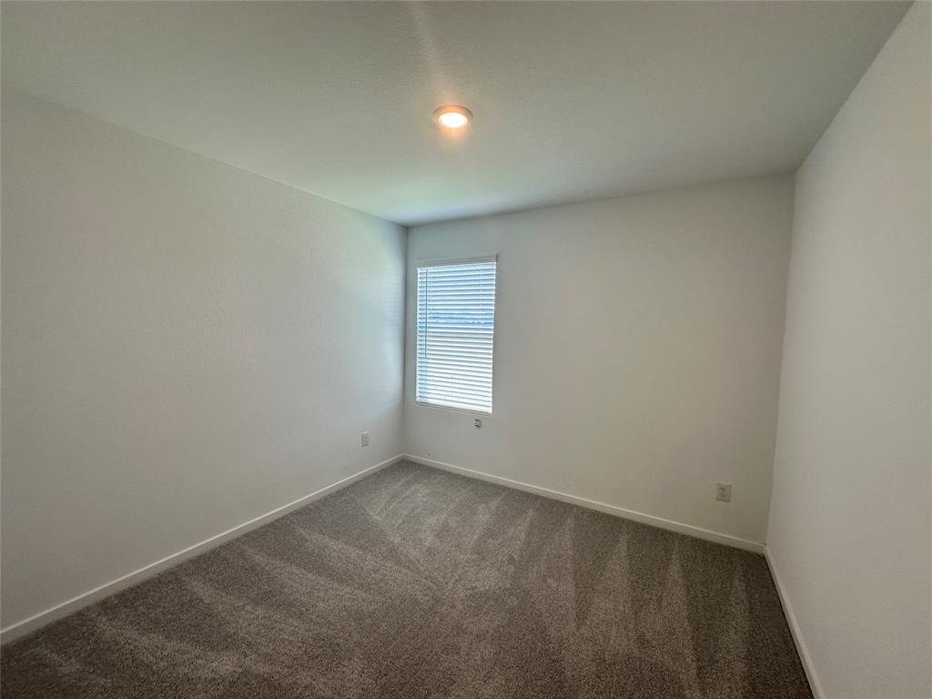 3800 Chambray Drive Sherman, TX 75092 - Photo 11 of 15 Spare room featuring dark carpet and baseboards