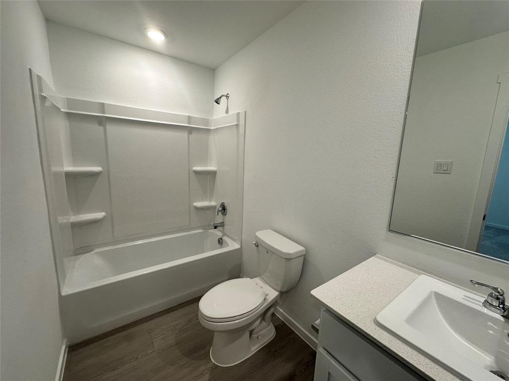 3800 Chambray Drive Sherman, TX 75092 - Photo 12 of 15 Full bath featuring tub / shower combination, dark wood-style flooring, vanity, and a textured wall
