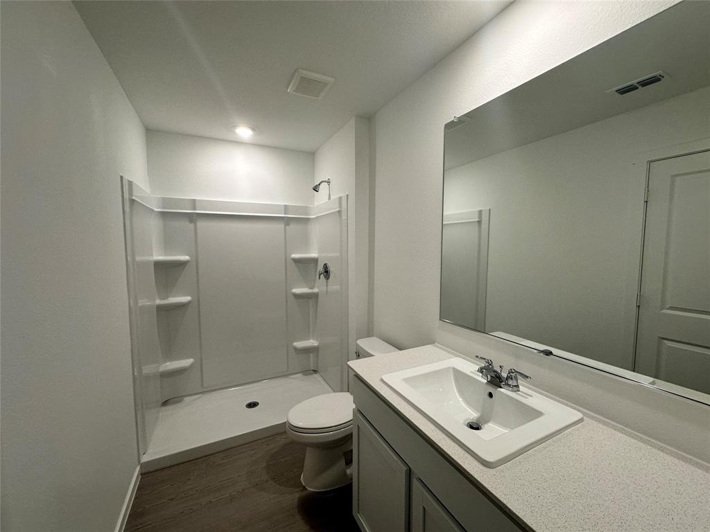 3800 Chambray Drive Sherman, TX 75092 - Photo 13 of 15 Full bathroom with vanity, a shower stall, and dark wood-type flooring