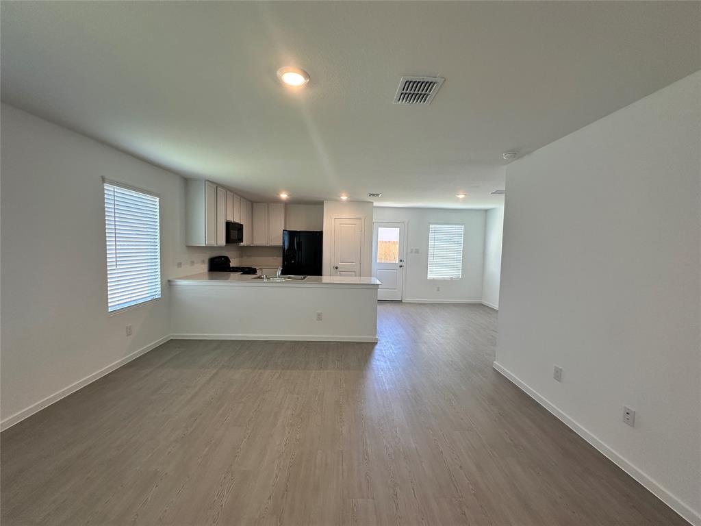 3800 Chambray Drive Sherman, TX 75092 - Photo 3 of 15 Unfurnished living room featuring light wood-style flooring and baseboards