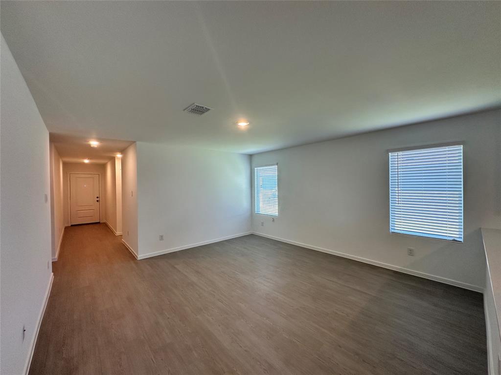 3800 Chambray Drive Sherman, TX 75092 - Photo 6 of 15 Empty room featuring baseboards and dark wood-style flooring