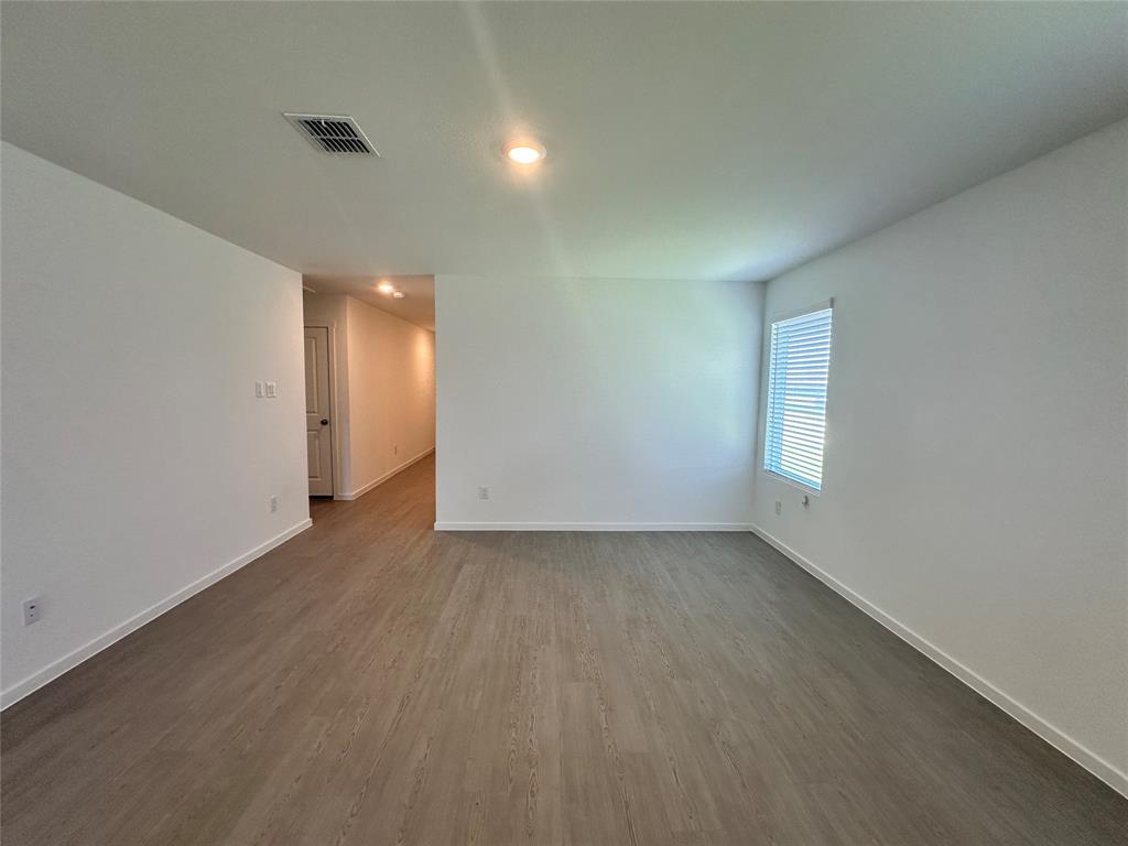 3800 Chambray Drive Sherman, TX 75092 - Photo 7 of 15 Empty room with dark wood finished floors and recessed lighting