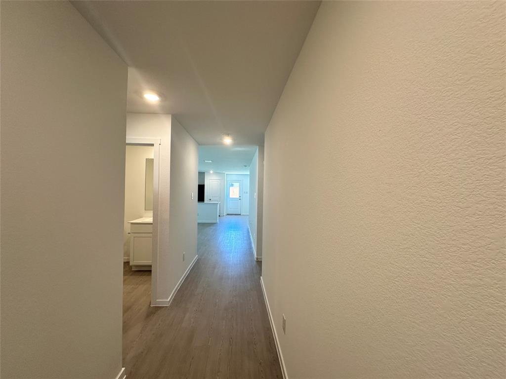 3800 Chambray Drive Sherman, TX 75092 - Photo 8 of 15 Hallway featuring dark wood-style flooring and baseboards