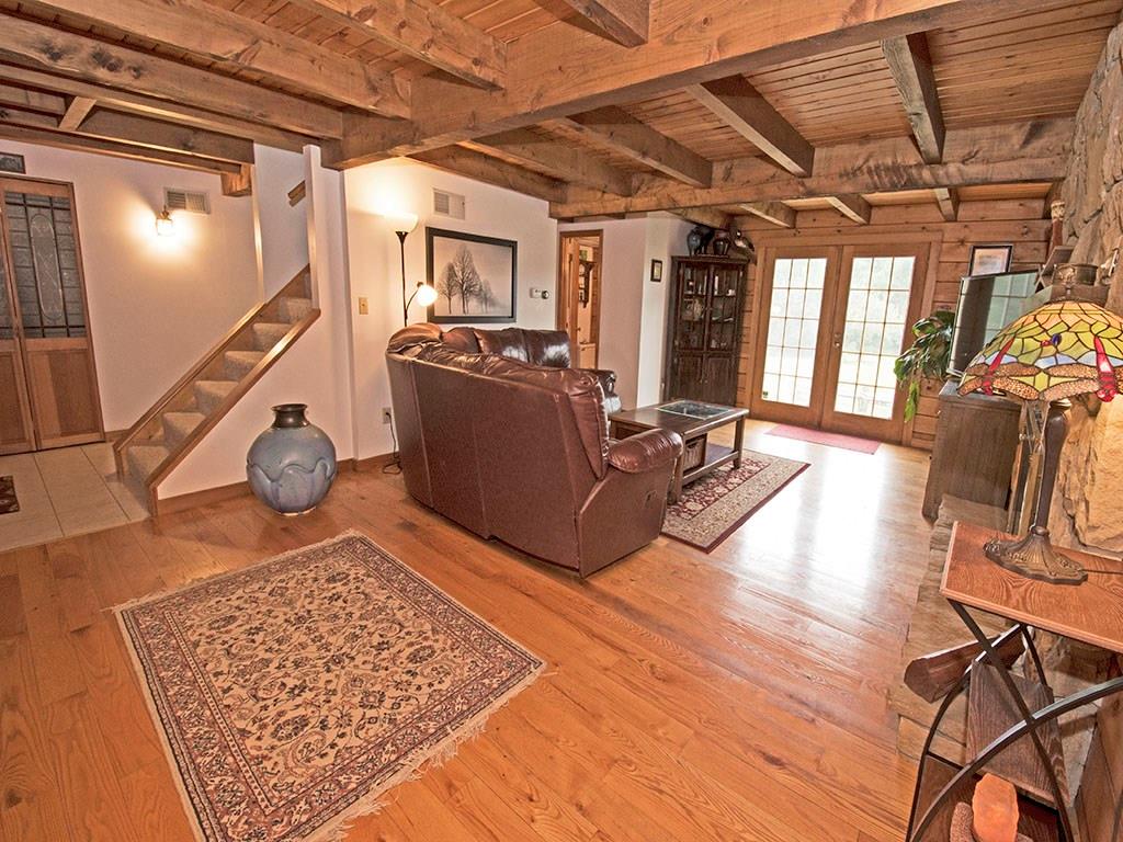 46 Henry Road Tarentum, PA 15084 - Photo 5 of 23 Large Living Room off of main entrance boasts Harwood Floors, Beamed Ceiling, Wood burning Stone Fireplace and French Doors leading outside.